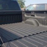 A Chevy truck with a spray on bed liner