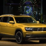 Yellow Volkswagen Atlas in front of a carnival at night