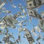Tons of one-hundred dollar bills falling from a blue sky