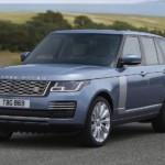 A blue Range Rover driving in the countryside