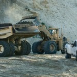 White 2018 Chevy Silverado 3500HD in sand pits with construction equipment