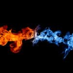 Black background with orange flames coming from the left and blue flames coming from the right