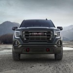 Black GMC Truck parked on a mountain top