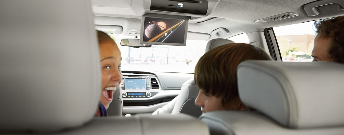 Children watching a video in the backseat of a 2018 Toyota Highlander