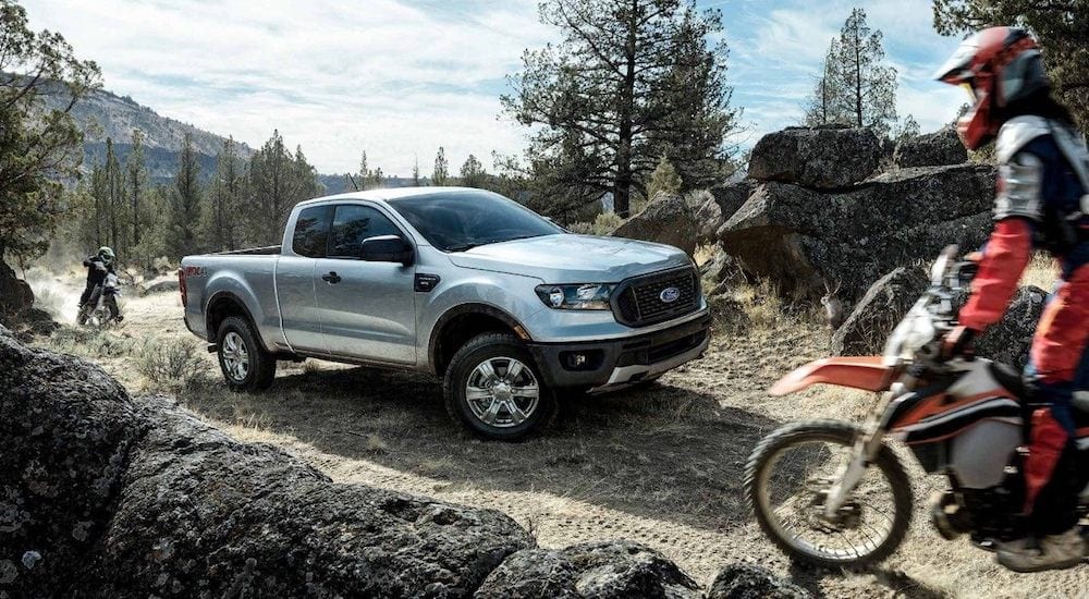 Silver 2019 Ford Ranger in mountains with 2 dirtbikes