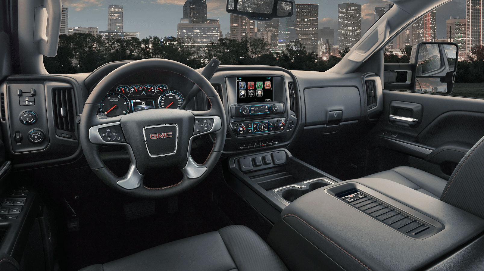 The interior of a 2019 GMC Sierra 2500HD Iwith cityscape in background