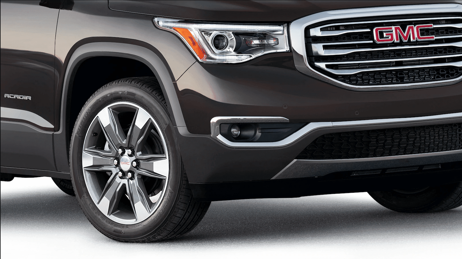 Closeup of brown 2019 GMC Acadia grille and wheel