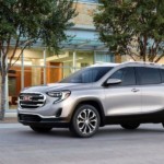 Silver 2019 GMC Terrain on tree lined road