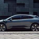 2019 Jaguar I-pace plugged in on city street with couple walking by