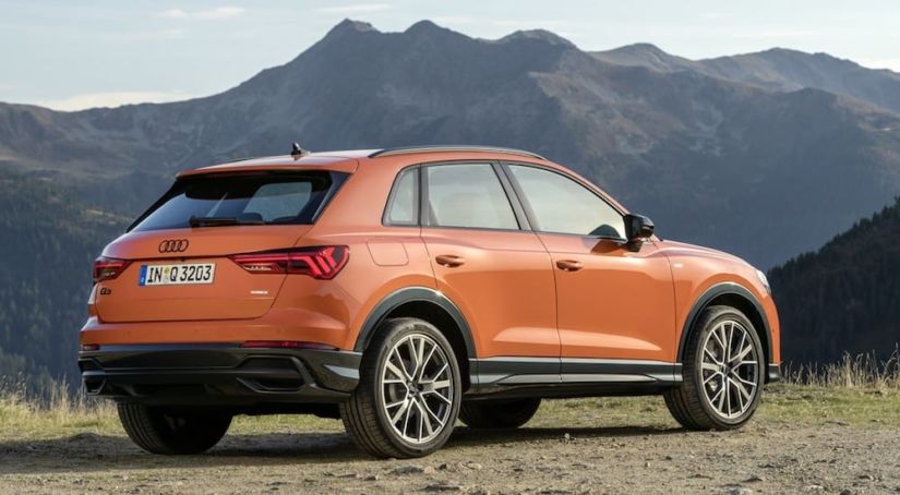 Orange 2019 Audi Q3 in front of mountains
