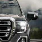 Closeup of grat 2019 GMC Sierra 1500 grille with mountains in background