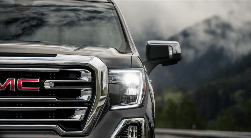 Closeup of grat 2019 GMC Sierra 1500 grille with mountains in background