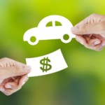 Left hand holding money, right hand holding car cutout