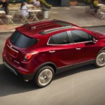 Red 2019 Buick Encore on road in front of cafe