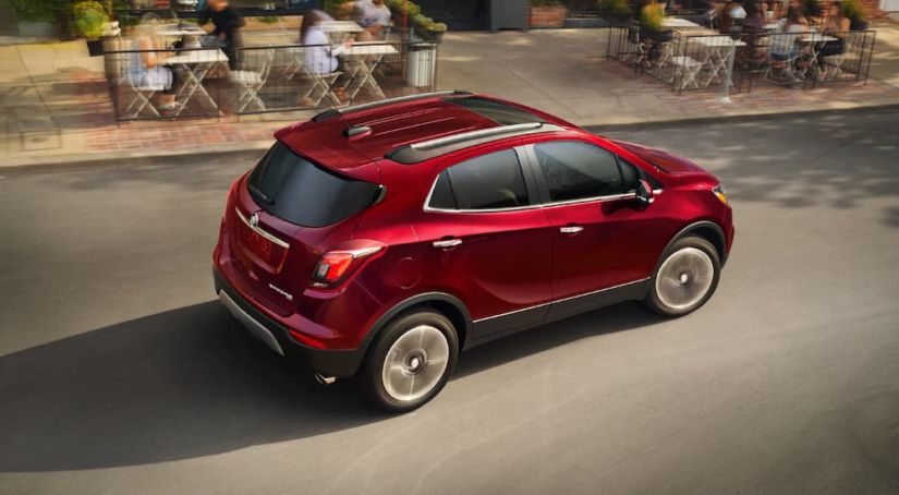 Red 2019 Buick Encore on road in front of cafe