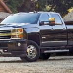 Black 2019 Chevy Silverado 3500 in front of log cabin