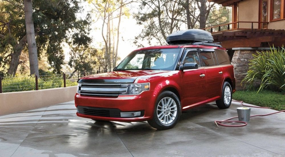 Red 2019 Ford Flex being washed in driveway