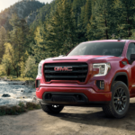 Red 2019 GMC Sierra 1500 next to woodland river