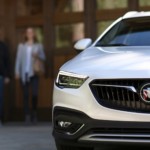 Couple walking toward white 2019 Buick Regal Tourx