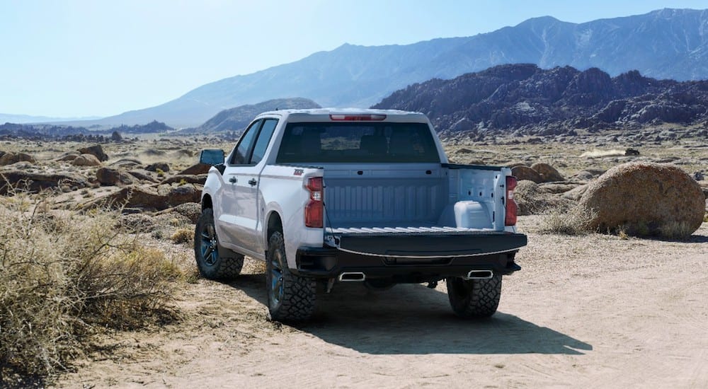 White 2019 Chevy Silverado with tailgate down in mountains