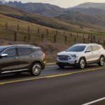 3 2019 GMC Terrains driving with mountains in back