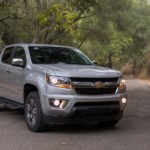 A silver 2019 Chevy Colorado diesel on a wooded road