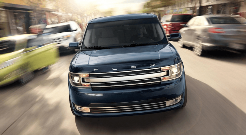 A blue 2019 Ford Flex from the front on an out of focus city street