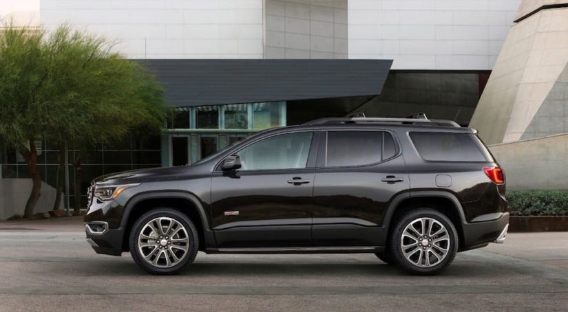A black 2019 GMC Acadia All Terrain parked in a driveway