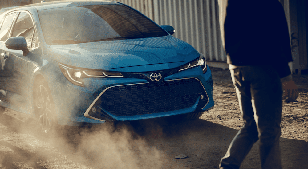 A blue 2019 Toyota Corolla hatchback kicking up dirt