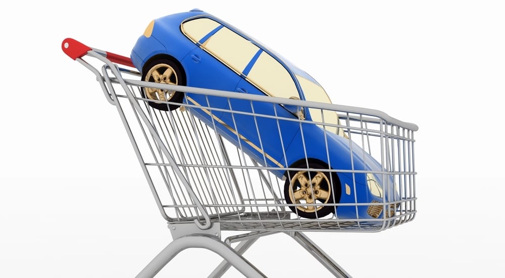 A blue car in a shopping basket for a no credit car loans dealer online