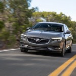 A gray 2019 Buick Regal Sportback driving down the road