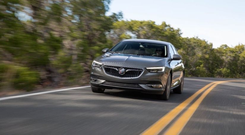 A gray 2019 Buick Regal Sportback driving down the road