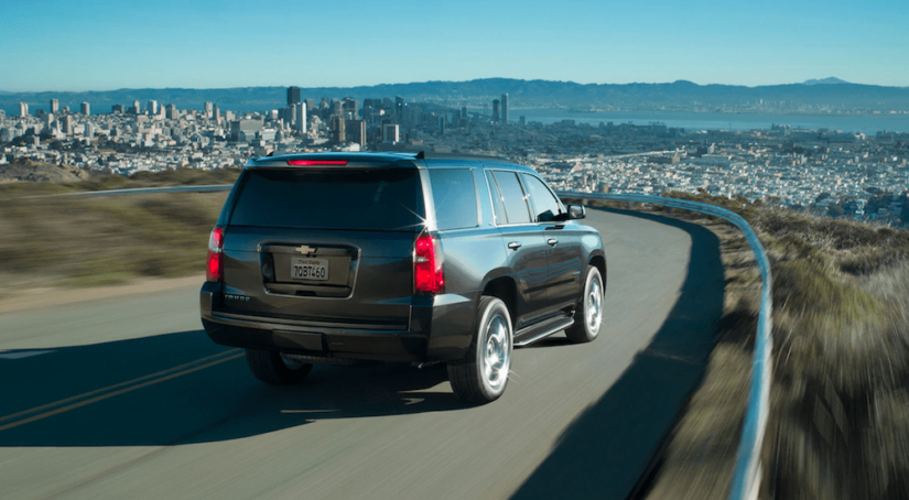 A black 2019 Chevy Tahoe drives away with the win for 2019 Chevy Tahoe vs 2019 Nissan Armada