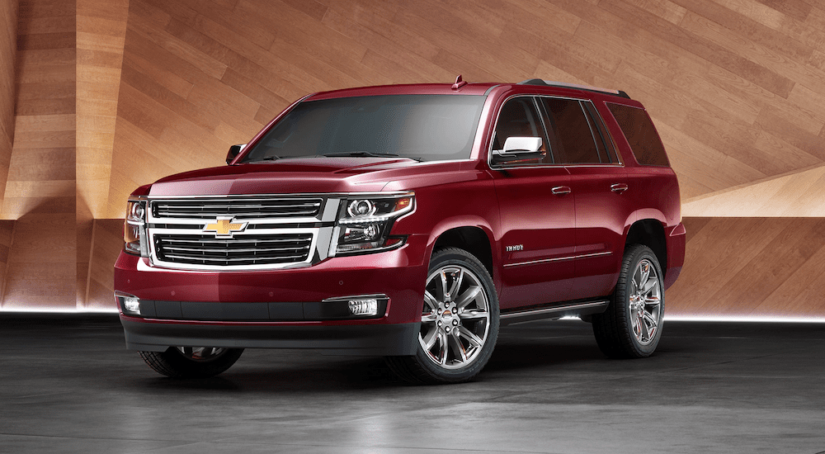 A red 2019 Chevy Tahoe in a wooden display room