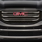A black GMC Acadia grille boldly claims the title in the battle of 2019 GMC Acadia vs 2019 Nissan Pathfinder