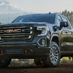 A black 2019 GMC Sierra 1500 in front of an epic snow capped mountian