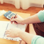 A women doing a monthly budget to help fix her credit