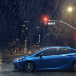 A blue 2019 Toyota Prius caught in the rain