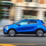A blue 2019 Buick Encore driving off with a win for 2019 Buick Encore vs 2019 Mazda CX-3