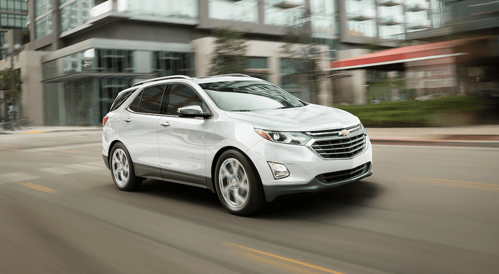 A white 2019 Chevy Equinox driving in a city