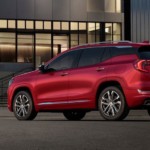 A red 2019 GMC Terrain Denali from a GMC dealer near me in front of a museum-looking building