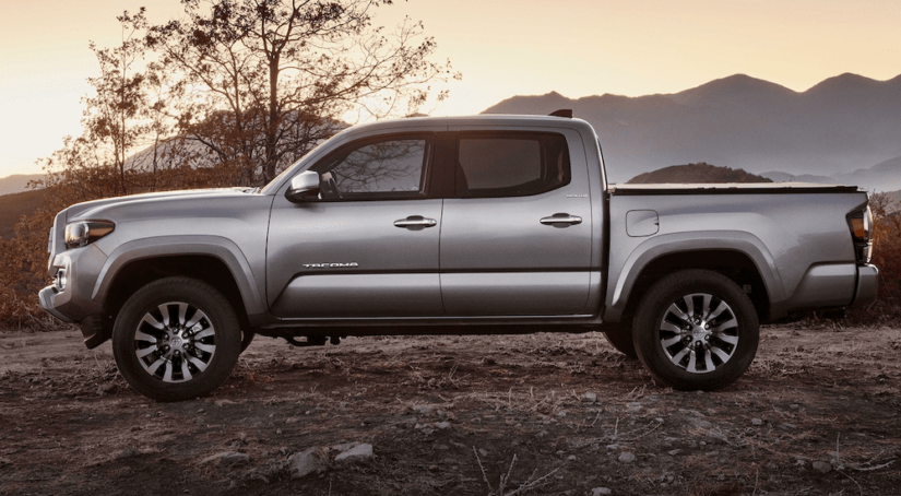 Silver 2020 Toyota Tacoma with mountains and sunset