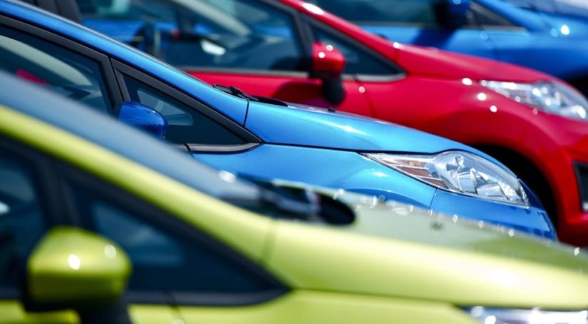 A closeup image of blue, green, and red cars.