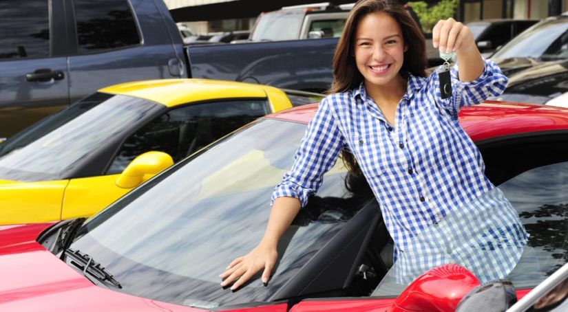 Smiling woman showing off the keys to her new car