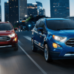 An image of two 2019 Ford Ecosports, one red and one blue, in a city