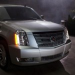 A used Cadillac SUV 2014 Escalade in a driveway at night