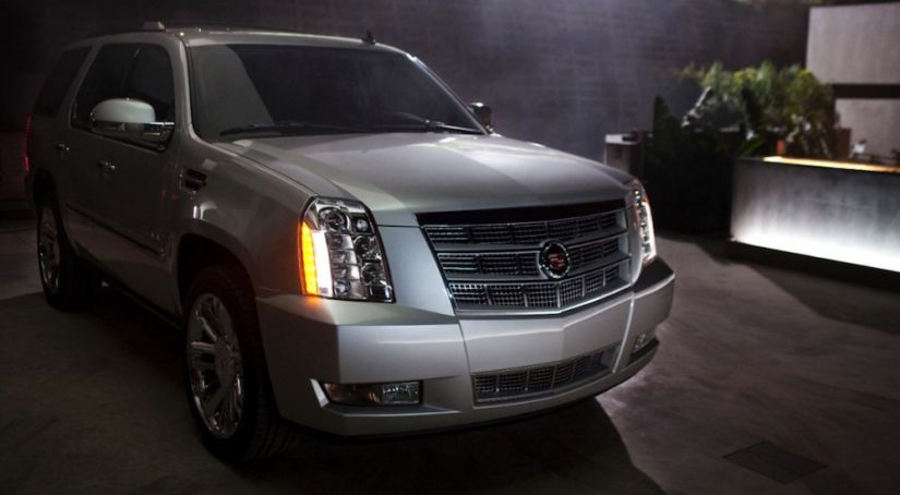 A used Cadillac SUV 2014 Escalade in a driveway at night