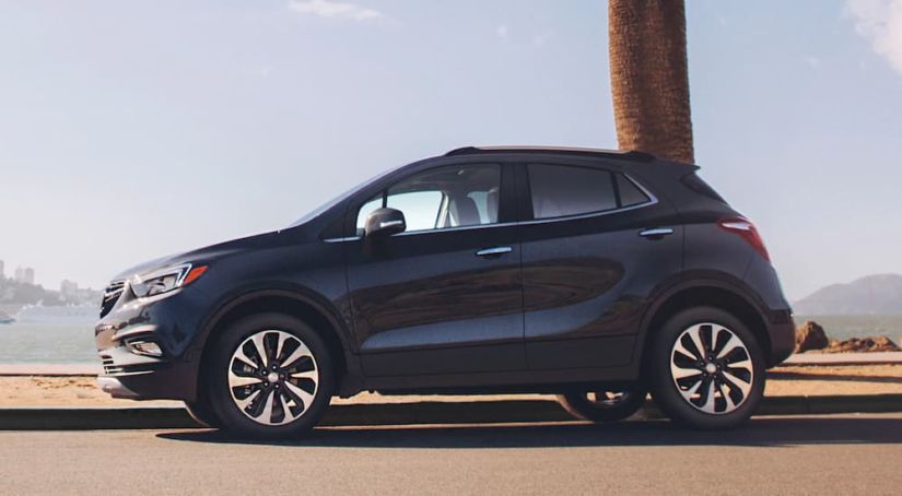 A black Encore drives in front of a bay after winning 2019 Buick Encore vs 2019 Nissan Kicks