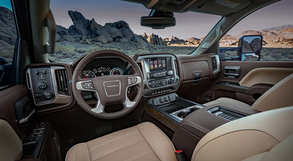 The brown and tan interior of the 2019 GMC Sierra 2500HD Denali is shown. Check out interior features when comparing the 2019 GMC Sierra 2500HD vs 2019 Ram 2500HD.