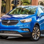 A blue 2019 Buick Encore is parked on a city street.